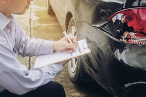 Claims specialist taking notes at the accident scene